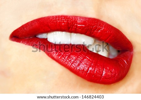 Sensuous woman biting red lips