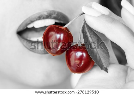 Sweet cherries pair in the front of young woman open mouth