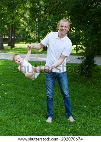 Father and baby training in park, sport concept, gymnastics