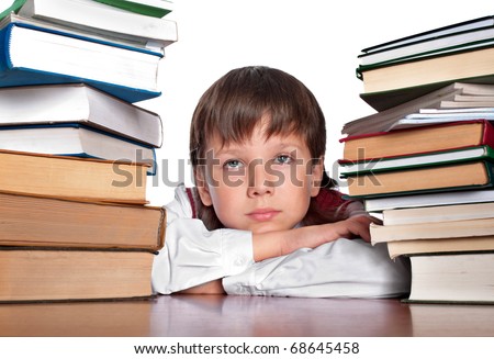 The schoolboy sits between two heaps of books and with melancholy thinks how to study all it