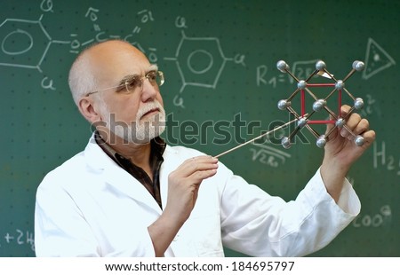 Teacher shows the class a little at a molecular model