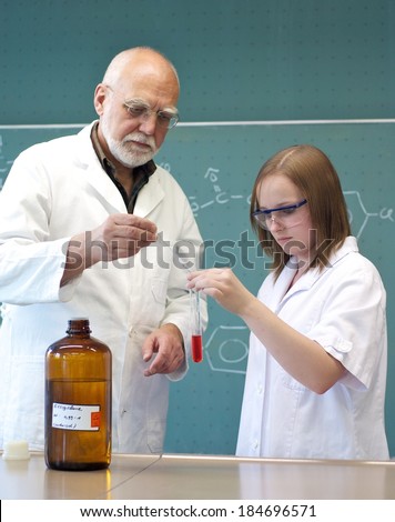 Student and teacher handle with a test tube