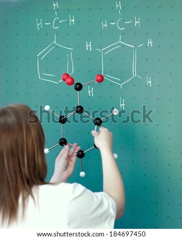 Student compares a molecule model in chemistry class