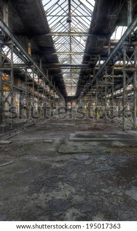 Abandoned old production hall with many plants and steel beams