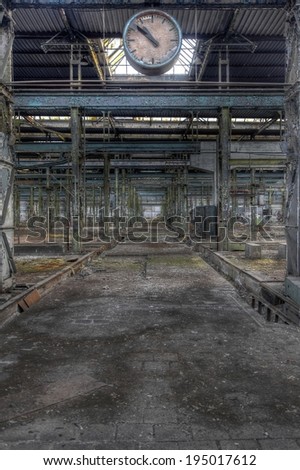 Old abandoned production hall with a clock
