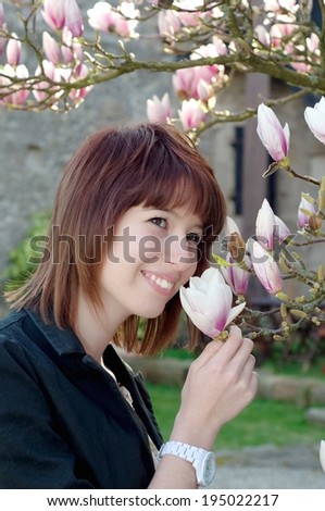 Woman smelling a flower in the garden