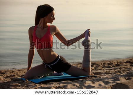 Woman near water in yoga pose. high contrast