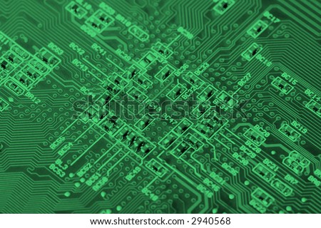 green board with electronics components, focus in center
