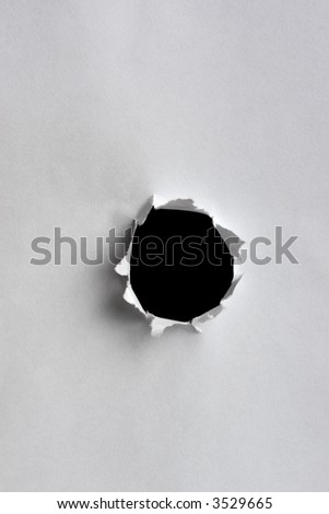 black hole in white paper with ragged edges