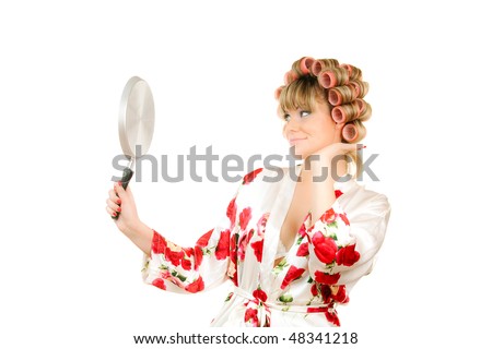 woman in hair curles look in frying pan like in mirror