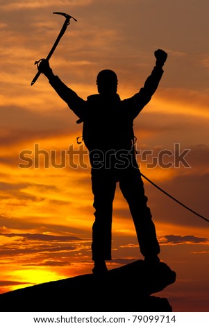 silhouette of rock climber on sunset sky