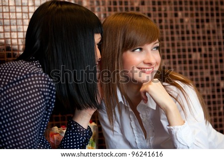 one woman whisper something to friend
