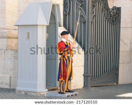 VATICAN CITY, ITALY- September 2 :Vatican, swiss guardsman stands in front of Vatican Museum on September 2, 2014 in Vatican, Rome, Italy. The Swiss Guards are responsible for the security of Vatican.