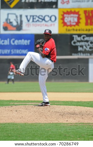 HICKORY, NC - JULY 21: Hickory Crawdads pitcher Ovispo De Los Santos takes the mound against the Delmarva Shorebirds, on July 21, 2010 at LP Frans Stadium in Hickory NC.