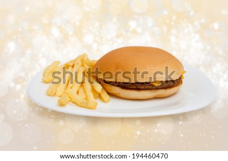 Cheeseburger on dinner plate with french fries isolated