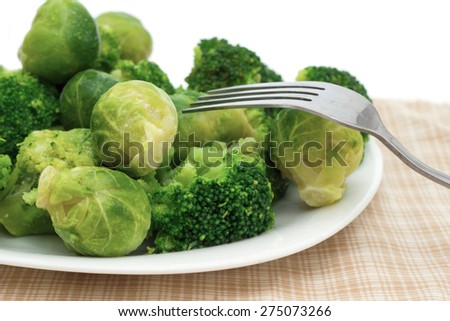 broccoli and Brussels sprouts on a plate with a fork