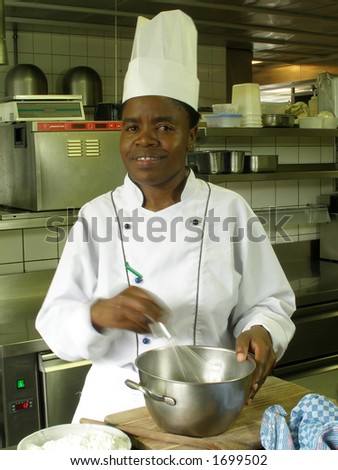 Black female chef is whisking the batter