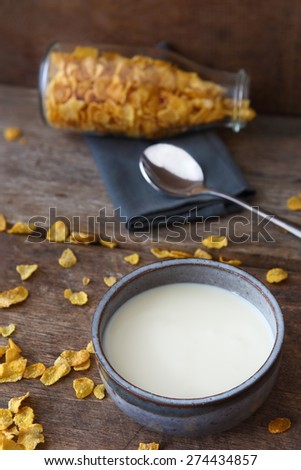 Cereal with Bowl of Milk on Wooden as Background.