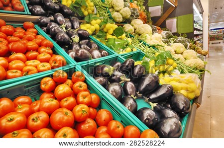 Fresh Vegetables, Tomato, Purple Eggplant, Lemon, on Shelf in Supermarket