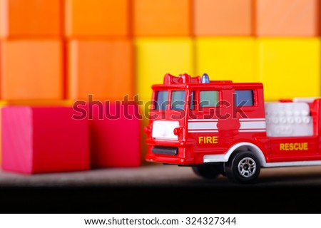 Closeup Toy Fire Engine on Colorful Wooden Blocks as Background.