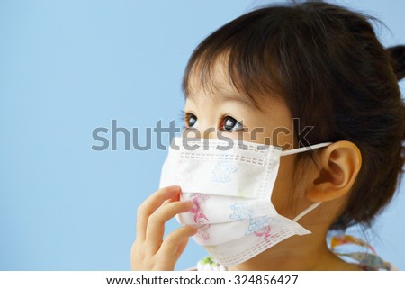 Asian Little Girl Gets Sick on Blue Background.
