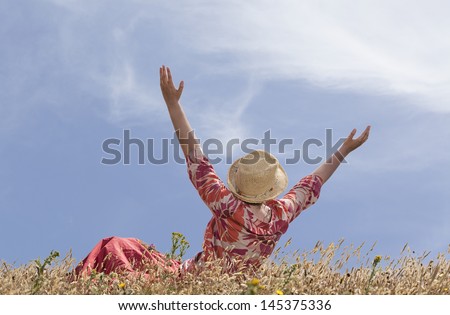 Woman with hands raised toward heaven