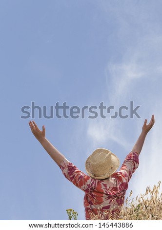 Woman with hands raised toward heaven