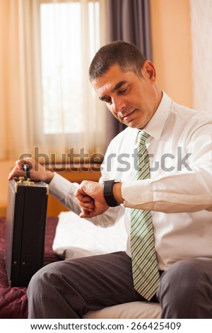 Businessman looking at his watch, he is ready for work