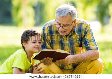 Grandfather and grandson learning about nature