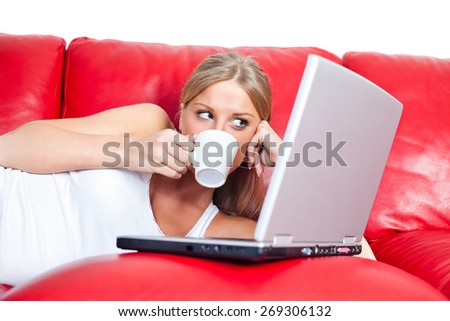 Girl surfing the net, having the cup of coffee