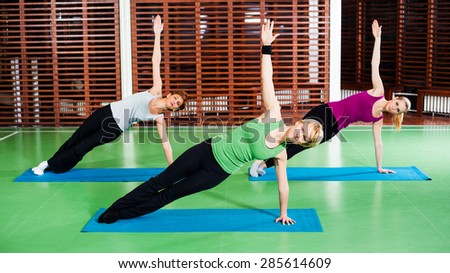 Girls practicing yoga, Yoga-Virabhadrasana / Rotated warrior pose