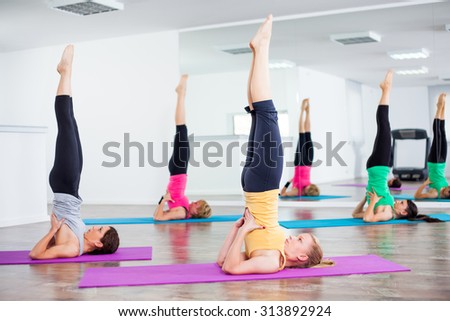 Girls practicing yoga, Yoga - Salamba Sarvangasana / Supported shoulder stand