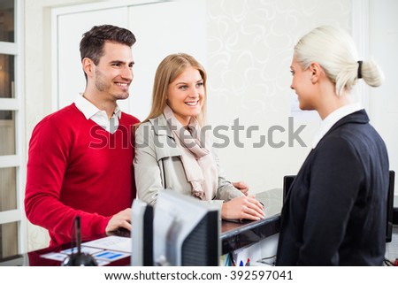Young couple check in at hotel reception