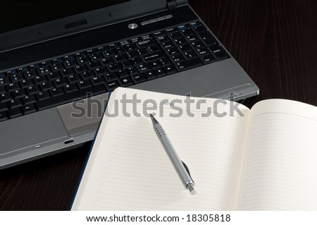 Laptop keyboard,notepad and pencil on office desk