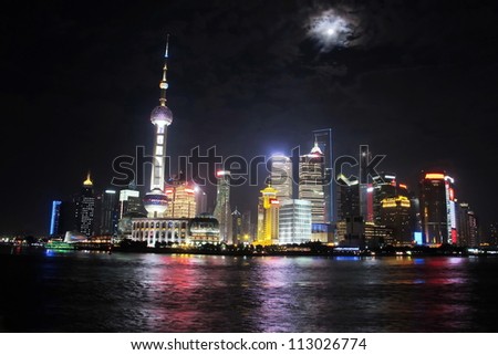 Shanghai tower with full moon night, China