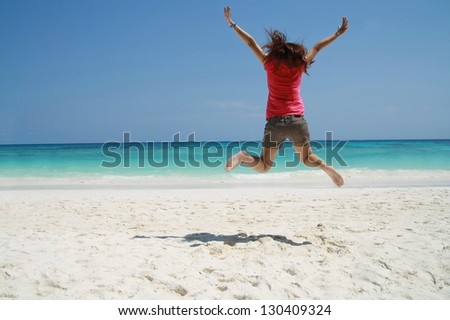 asia women jump on beach