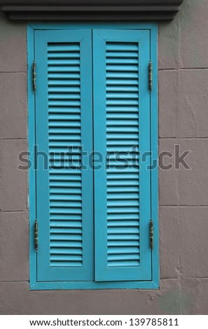 blue wood window on gray wall