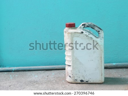 old benzine gallon  on blue wall