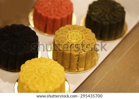 Retro vintage style Chinese mid autumn festival foods. Traditional mooncakes on table setting with teacup. The Chinese words on the mooncakes means assorted fruits nuts,
