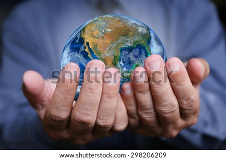 businessman hand hold the earth , politics or environmental conservation Earth image courtesy of Nasa
