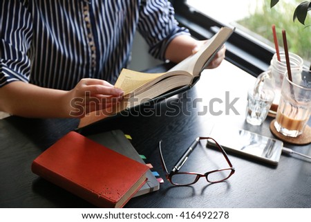 women hand open book for reading