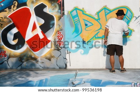 CHIANG MAI, THAILAND - APRIL 7: A young graffiti artist during drawing and painting his 3D artwork in Chiang Mai Fest and Art on the Street 2012, On April 7, 2012 in Chiang Mai, Thailand.