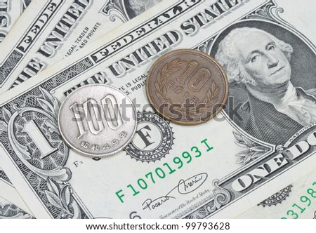 Japan coin on dollar bill
