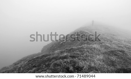 Hiking man in the fog. Cloudy Slovakian Tatra Mountains. B&W