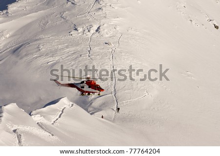 Helicopter mountain rescue service in the winter. Swinicka Pass in the High Tatras
