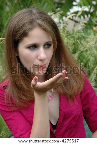 young lady in hot pink shirt blowing a kiss