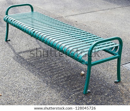 Empty green metal bench