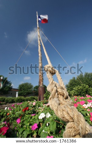 Texas flag on an old timber with anchor rope in foreground