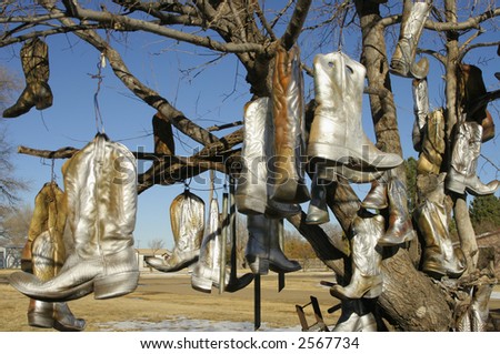 Old cowboy boots hanging from a tree in Vega, TX on Route 66