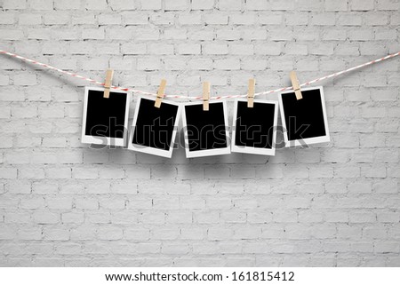 polaroid photo frame on brick wall.